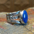 Sterling silver ring with lapis set in the bezel and patterned stamping on the band.