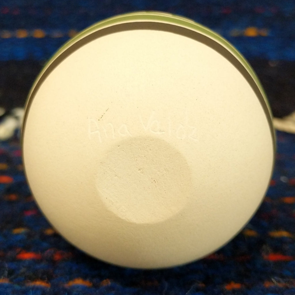 The artist's signature is etched into the base of the piece.