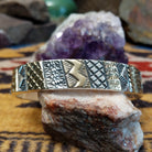 Sterling silver and 14k gold cuff by Marc Antia with alternating patterned panels.
