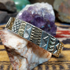 Sterling silver and 14k gold cuff by Marc Antia with alternating patterned panels.