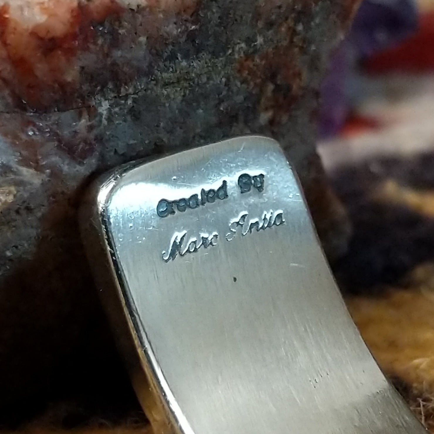 Close up of the artist's stamped signature.