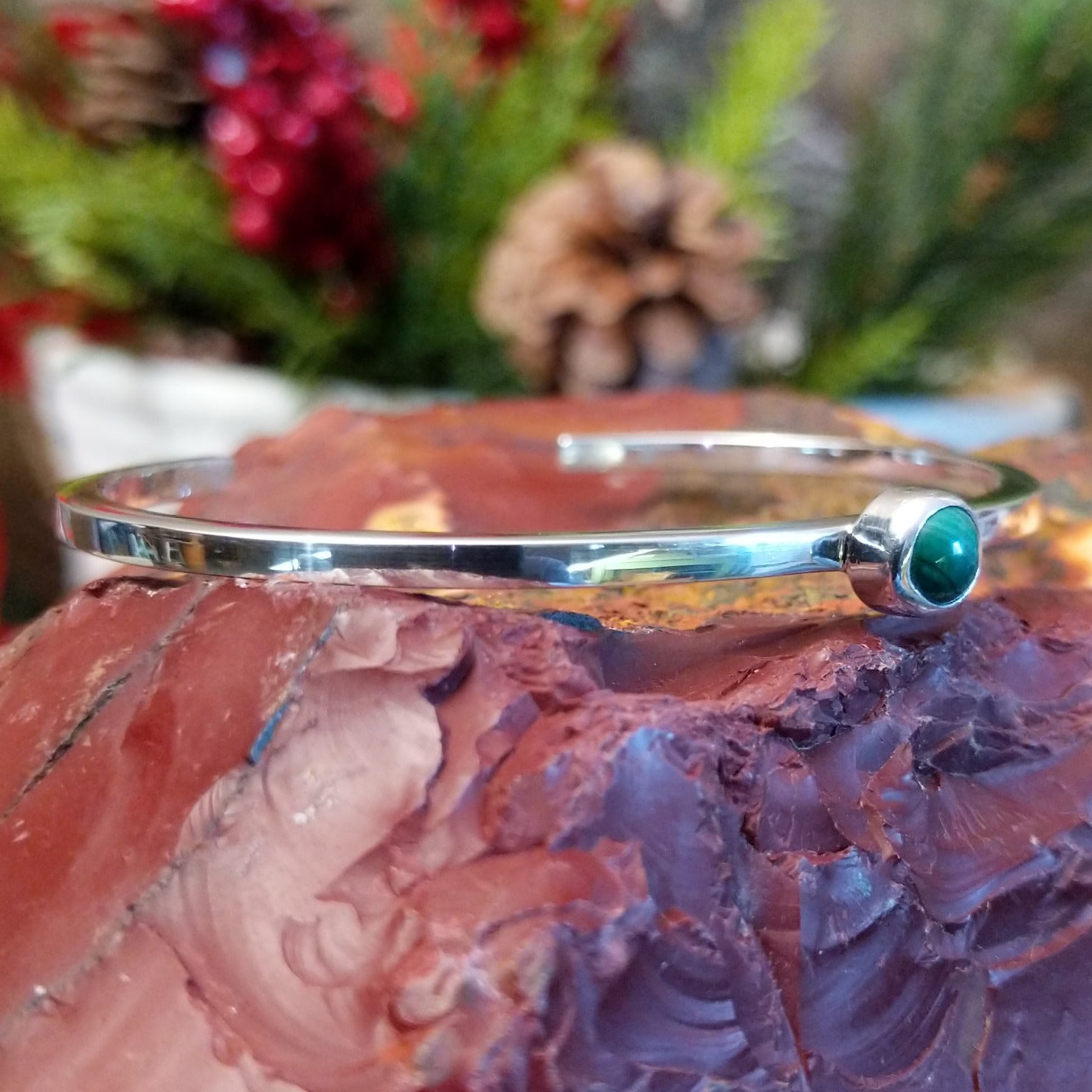 Thin sterling silver cuff bracelet with petite malachite stone set in the bezel.