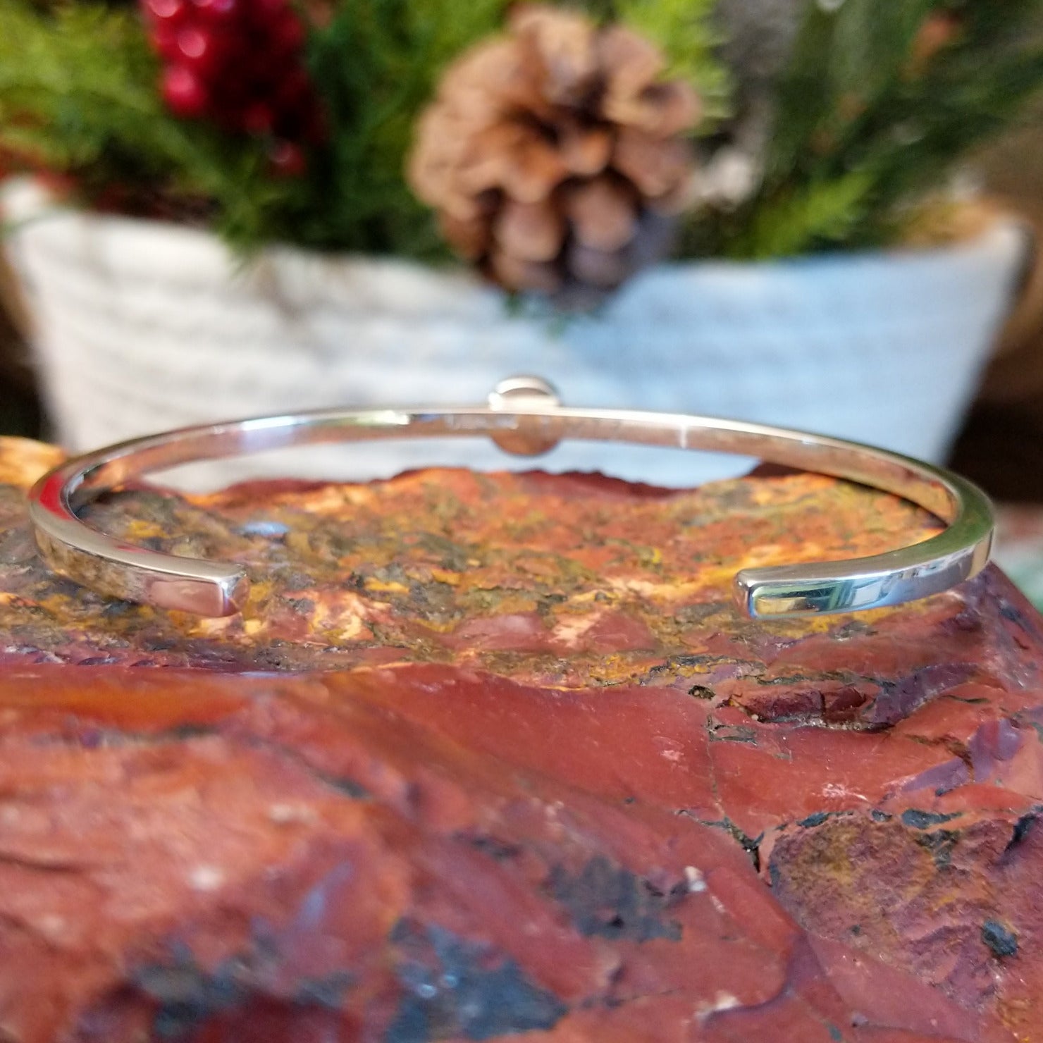 Polished sterling silver band of the cuff.