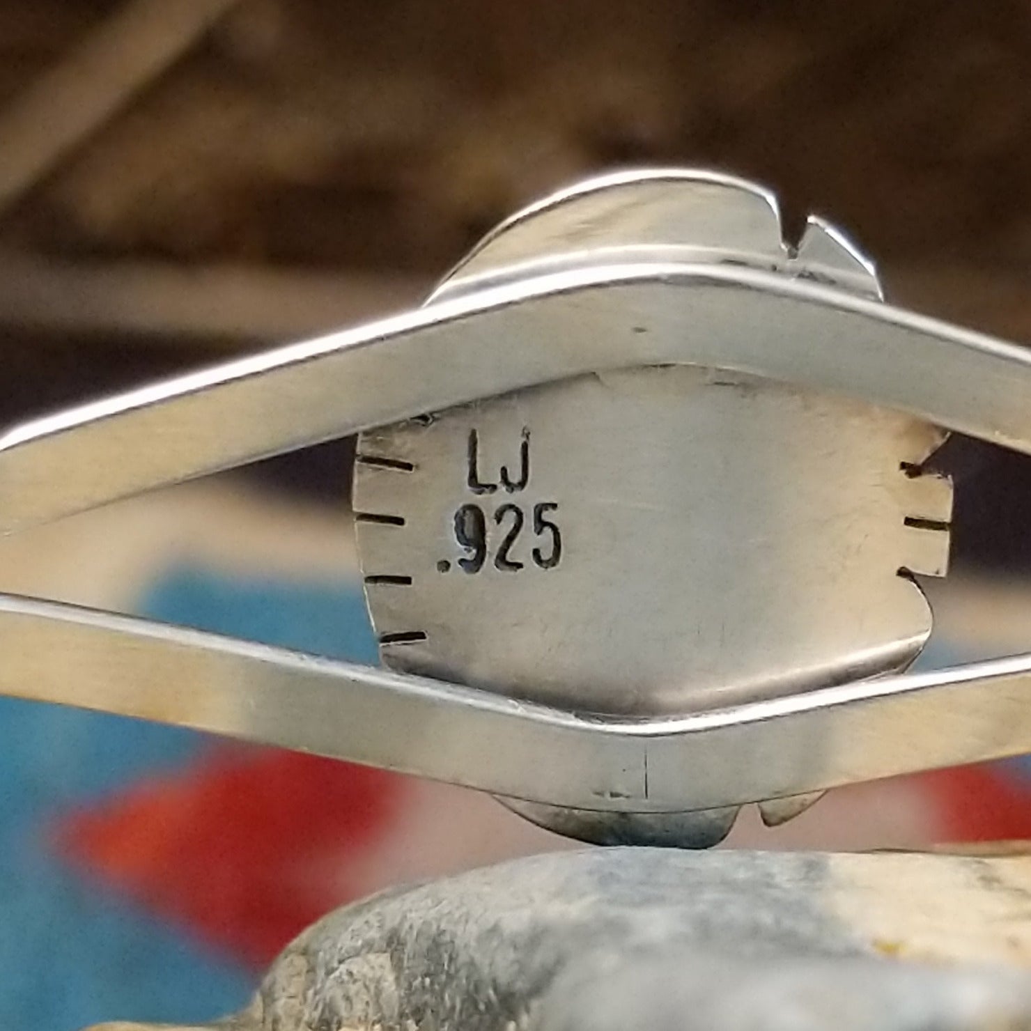 Close-up of the artisan's stamped signature.