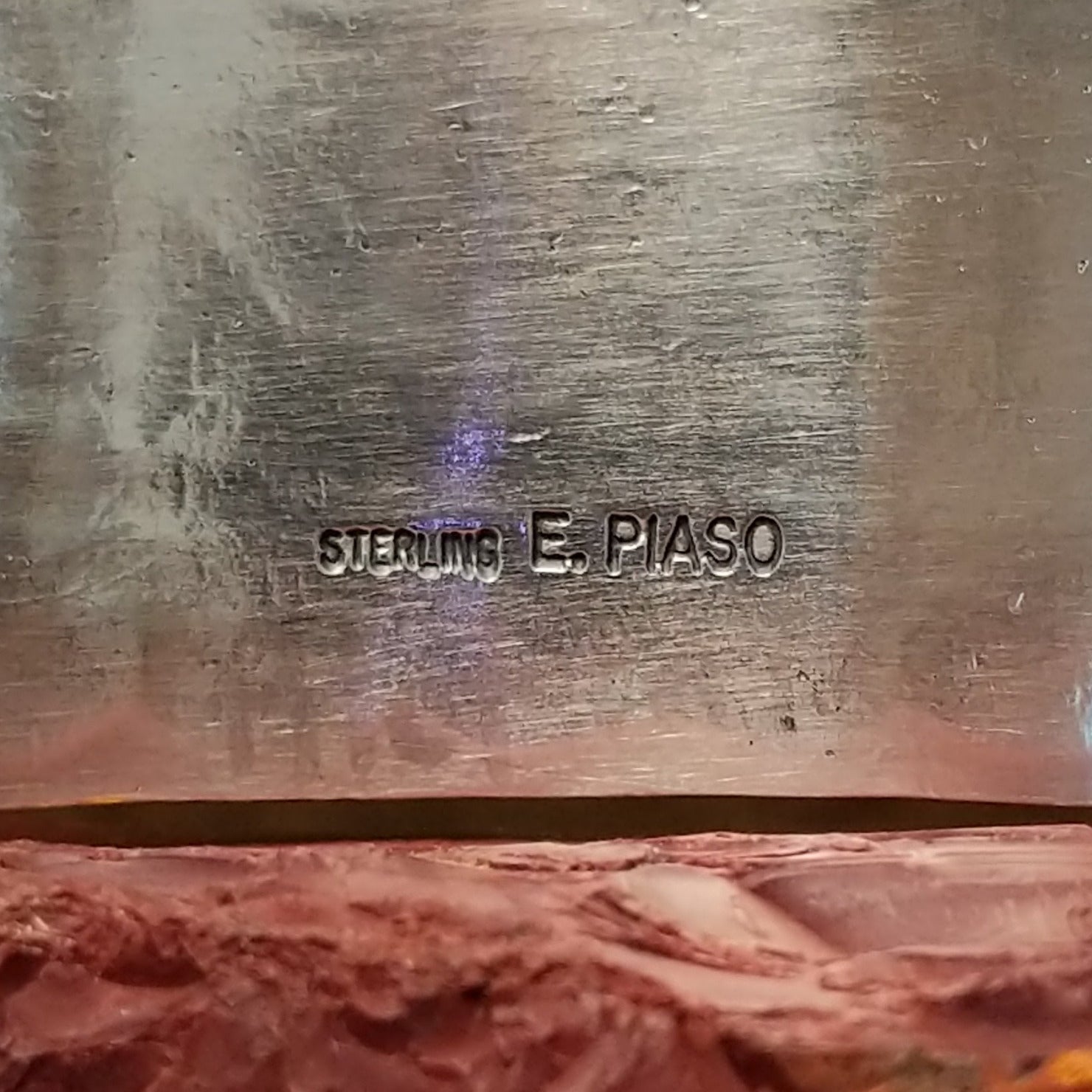 Close-up of the artist's stamped signature.
