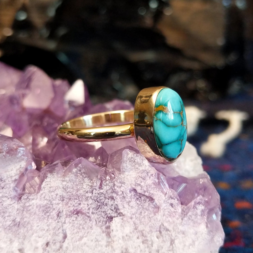 Profile of the ring highlighting the thickness of the bezel and sleek curvature of the thin band.