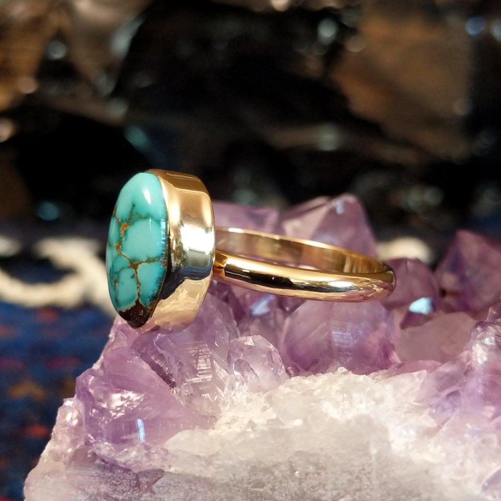 Profile of the ring highlighting the thickness of the bezel and sleek curvature of the thin band.