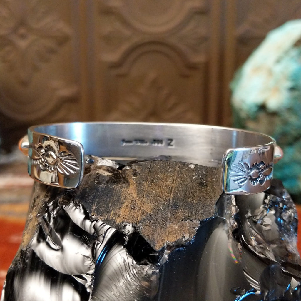 The tips of the cuff feature a stamped design.