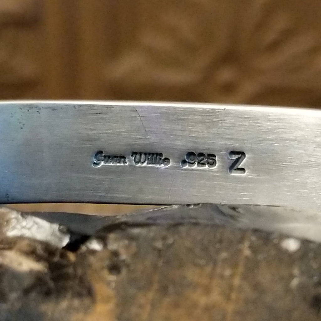 Close-up of the artisan's stamped signature.