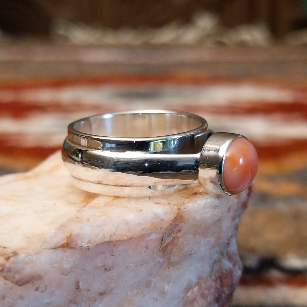 Sterling silver ring with a pink coral set in a raised bezel.