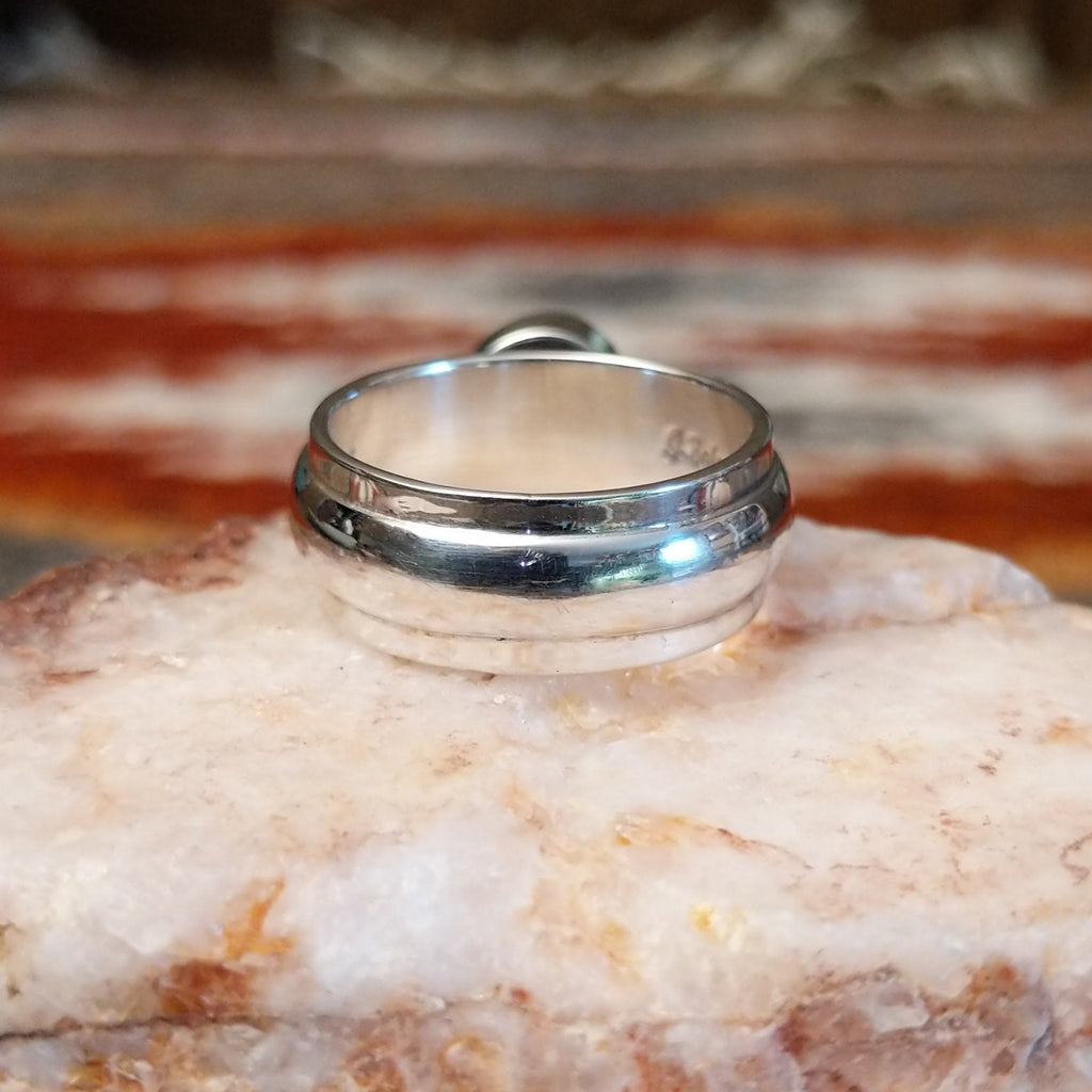 Sterling silver ring with a pink coral set in a raised bezel.