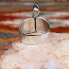 Sterling silver ring with trio bezels and pink coral set within.