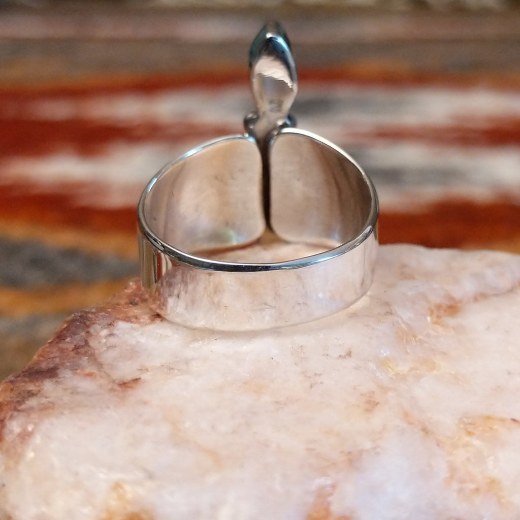 Sterling silver ring with trio bezels and pink coral set within.