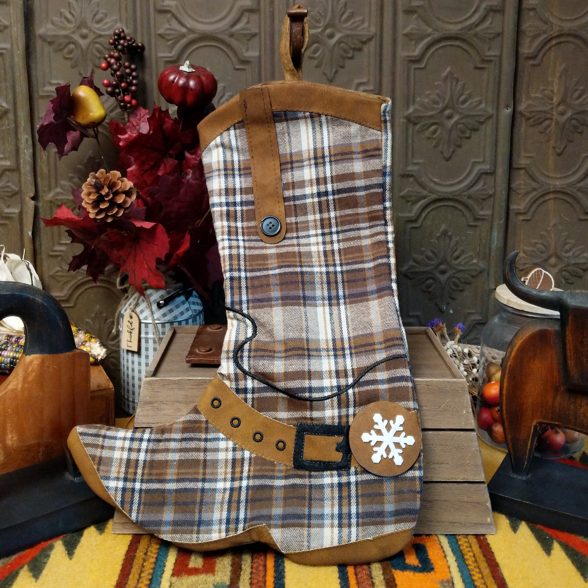 This charming collection of 18-inch Plaid Boot Stockings features cowboy boot designs in assorted plaid patterns with decorative buckles, snowflakes, festive accents, and hanging loops for Western Christmas decorating.