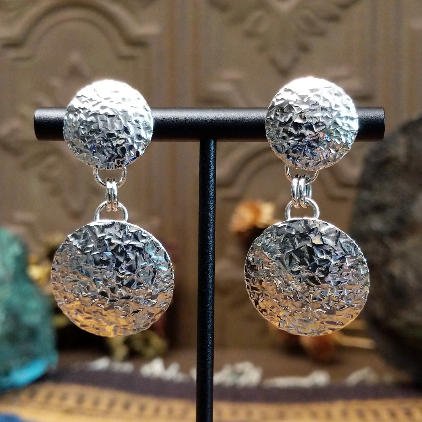 Sterling silver planished circle earrings featuring textured round dangles and matching textured stud tops.