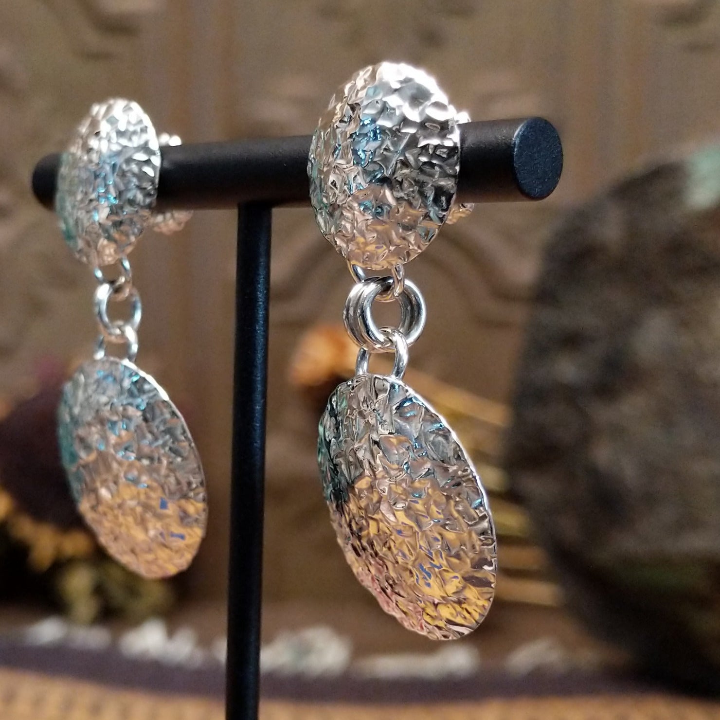 Sterling silver planished circle earrings featuring textured round dangles and matching textured stud tops.