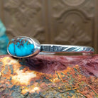 Sterling silver cuff featuring Redskin turquoise set in an oval bezel.