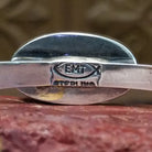 Close-up of artist's stamped signature.