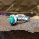 Sterling silver ring featuring Sonoran gold turquoise set in an round bezel with a planished finish.