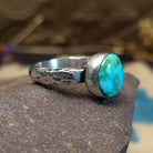 Sterling silver ring featuring Sonoran gold turquoise set in an round bezel with a planished finish.