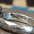 Close-up of the artisan's stamped signature.