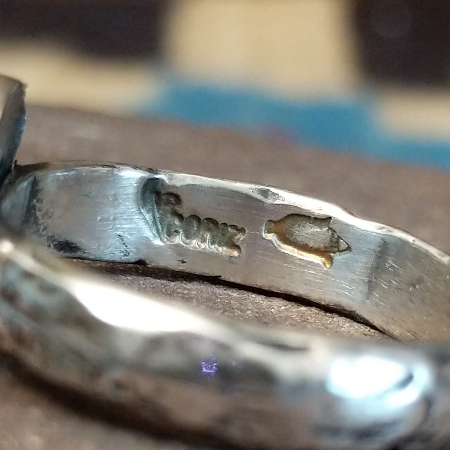 Close-up of the artisan's stamped signature.