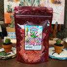 Sour prickly pear gummy bears coated in tangy sugar crystals, displayed in a colorful pile. Vibrant pink gummy candies with a chewy texture and a sweet-tart prickly pear flavor.