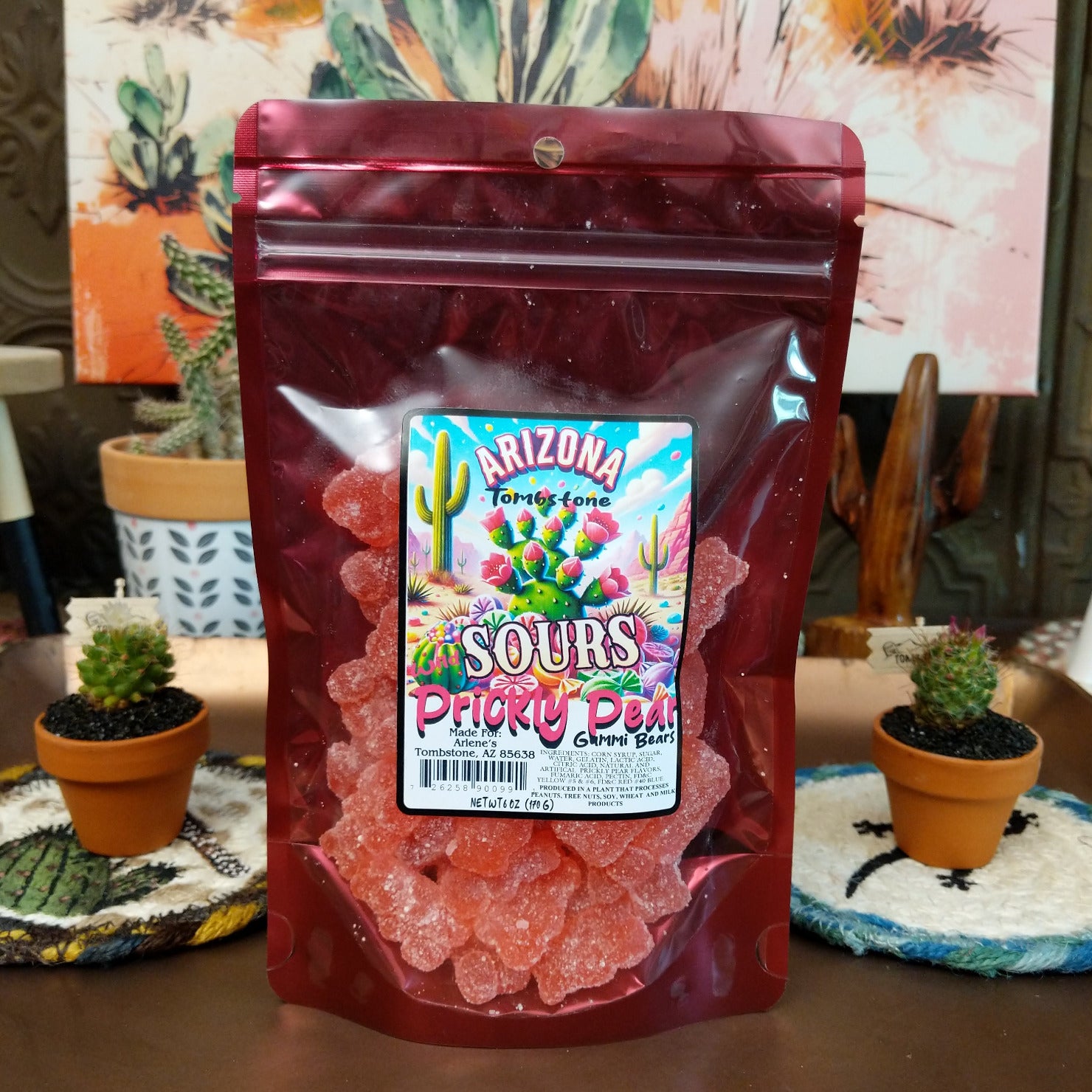 Sour prickly pear gummy bears coated in tangy sugar crystals, displayed in a colorful pile. Vibrant pink gummy candies with a chewy texture and a sweet-tart prickly pear flavor.