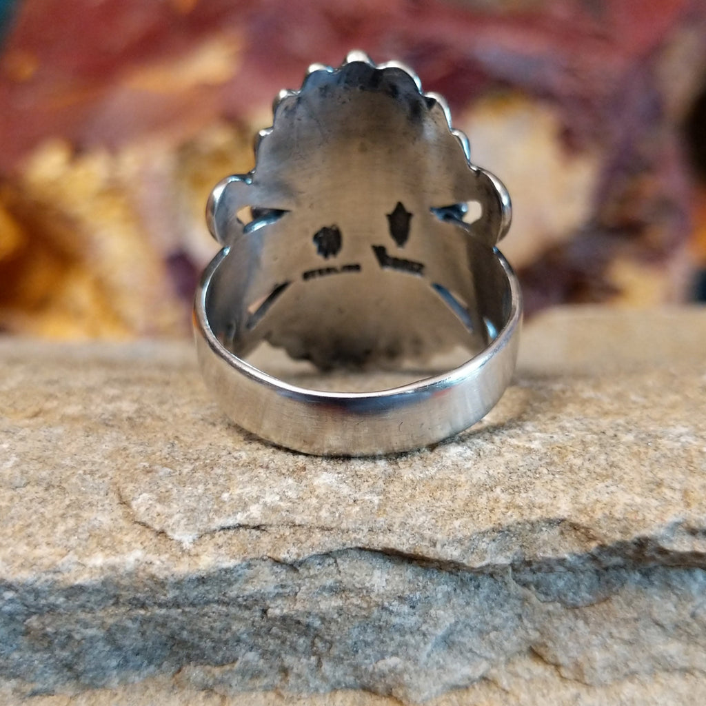 The sterling silver band of the ring is polished.