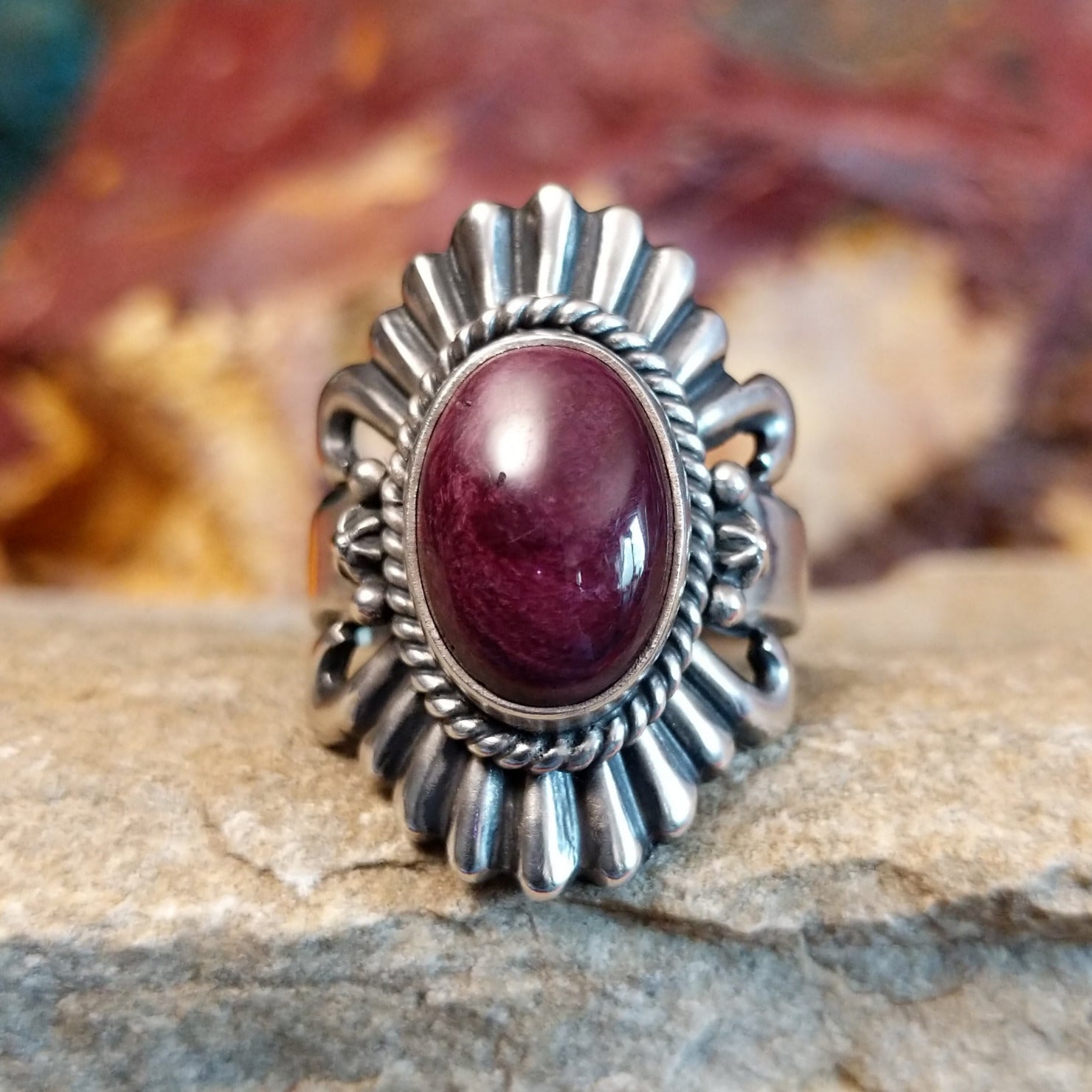 Oval purple spiny oyster shell set in sterling silver with twisted rope accents and ornate silver detailing.