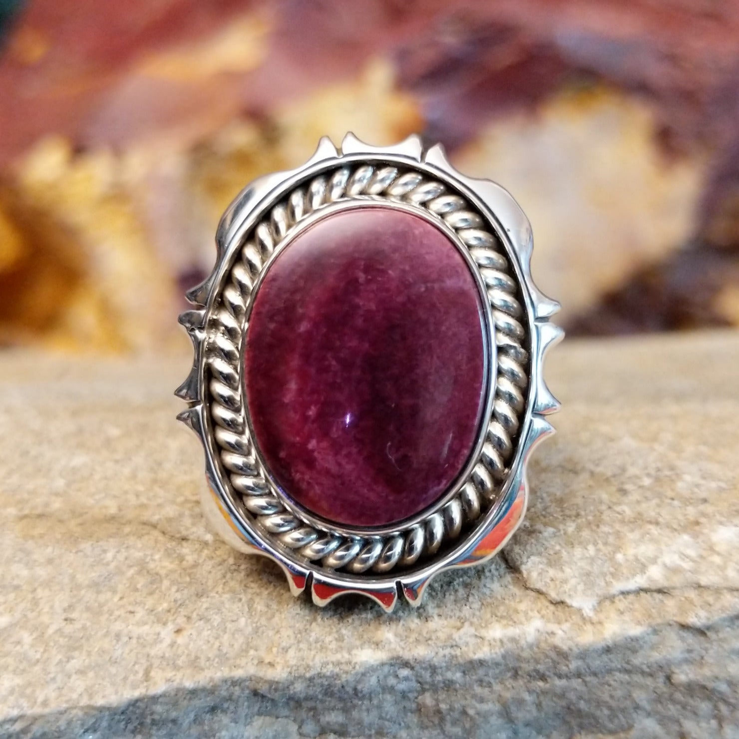 Oval purple spiny oyster shell set in a twisted rope and incised sterling silver setting.