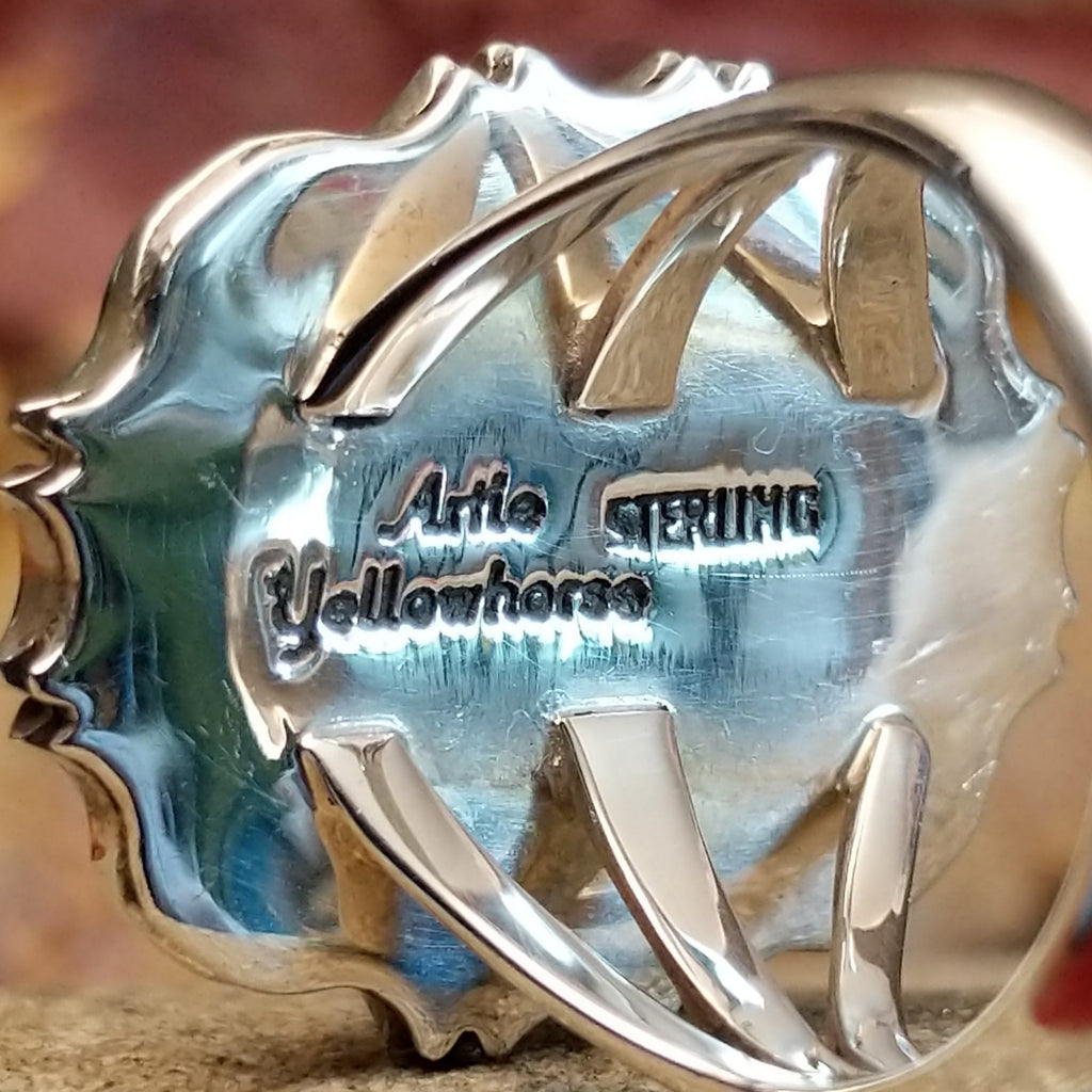 The artisan's stamped signature is found on the underside of the bezel.