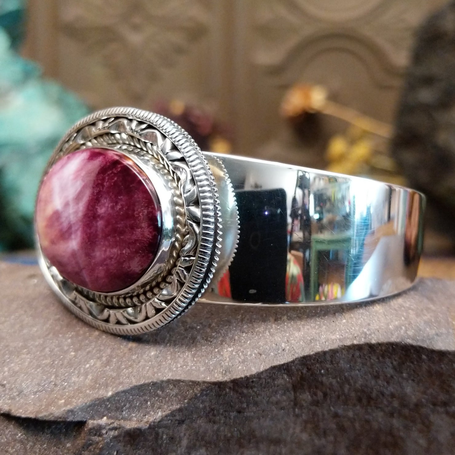 Sterling silver cuff featuring purple spiny oyster shell set in a twisted rope bezel.