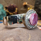 Sterling silver cuff featuring purple spiny oyster shell set in a twisted rope bezel.