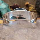 Sterling silver cuff featuring purple spiny oyster shell set in a twisted rope bezel.