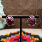 This vibrant Purple Spiny Oyster Shell Oval Earrings set by Priscilla Smith features oval purple shell cabochons set in polished silver with twisted rope-style borders.
