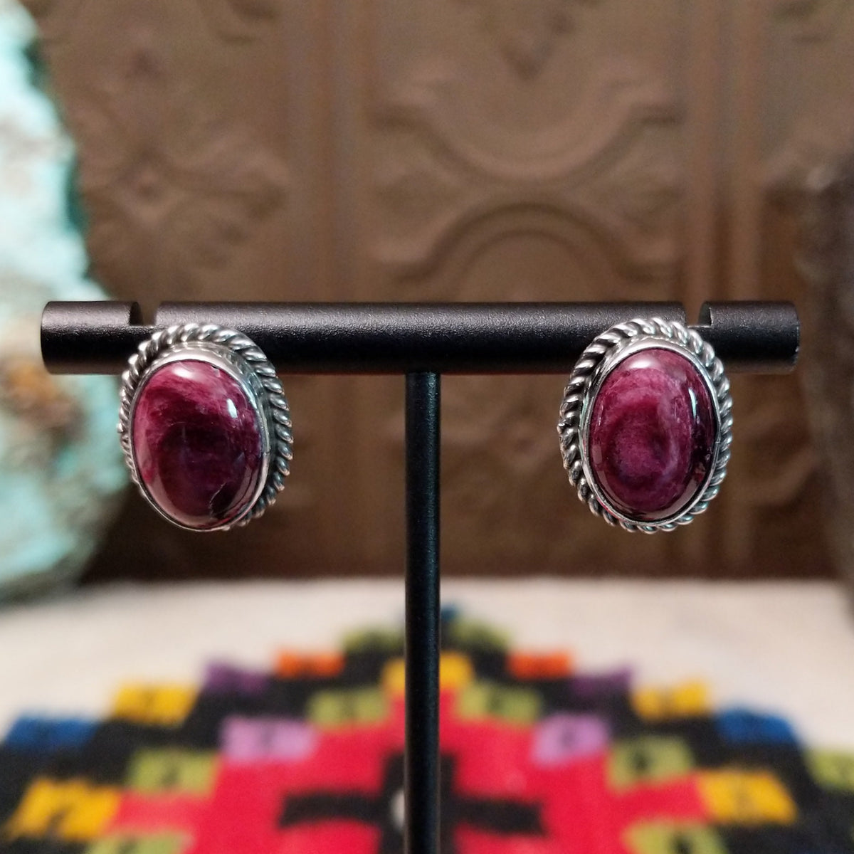This vibrant Purple Spiny Oyster Shell Oval Earrings set by Priscilla Smith features oval purple shell cabochons set in polished silver with twisted rope-style borders.