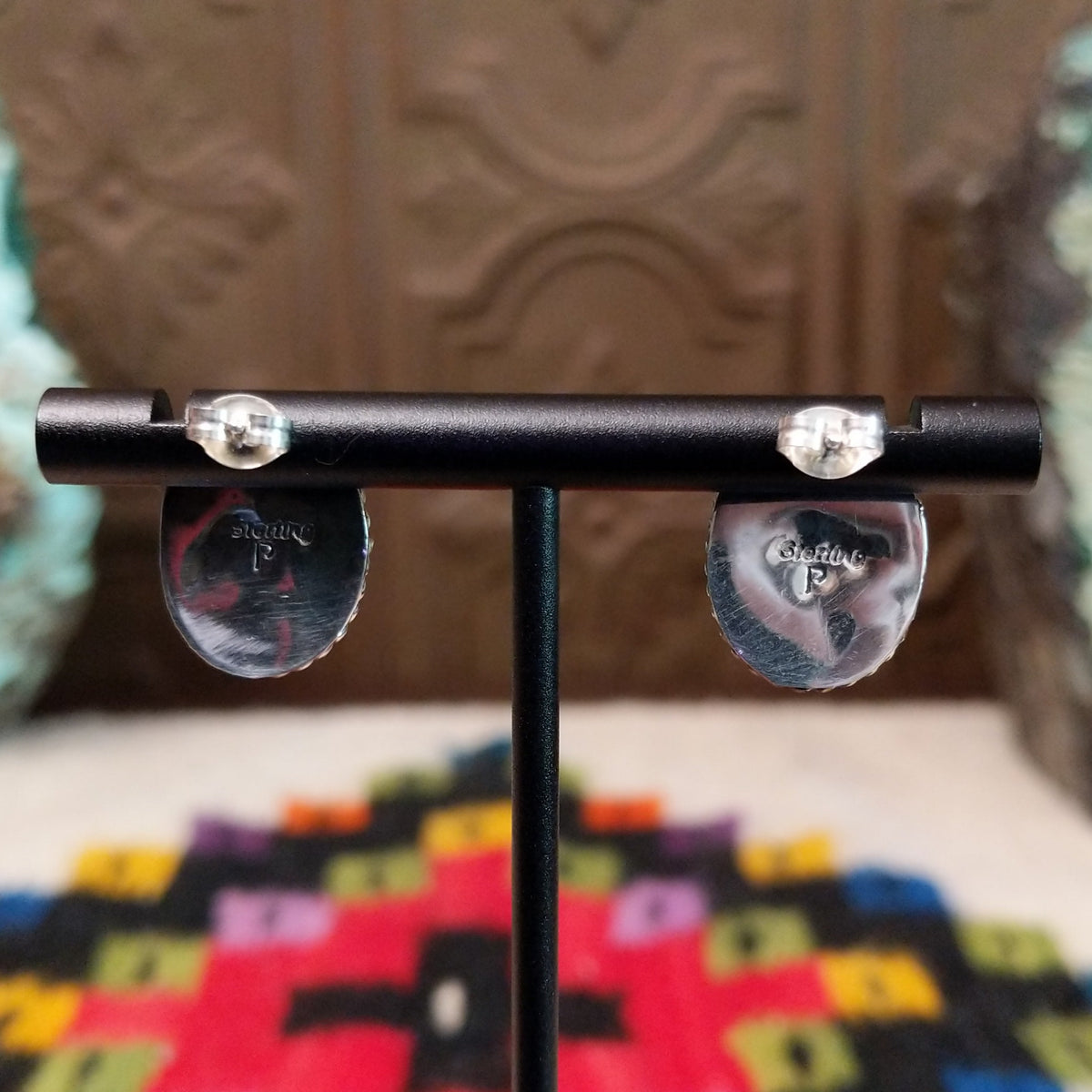 This vibrant Purple Spiny Oyster Shell Oval Earrings set by Priscilla Smith features oval purple shell cabochons set in polished silver with twisted rope-style borders; artisan and Sterling Silver stamp.
