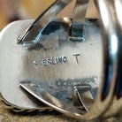 The artisan's stamp is found on the underside of the bezel.