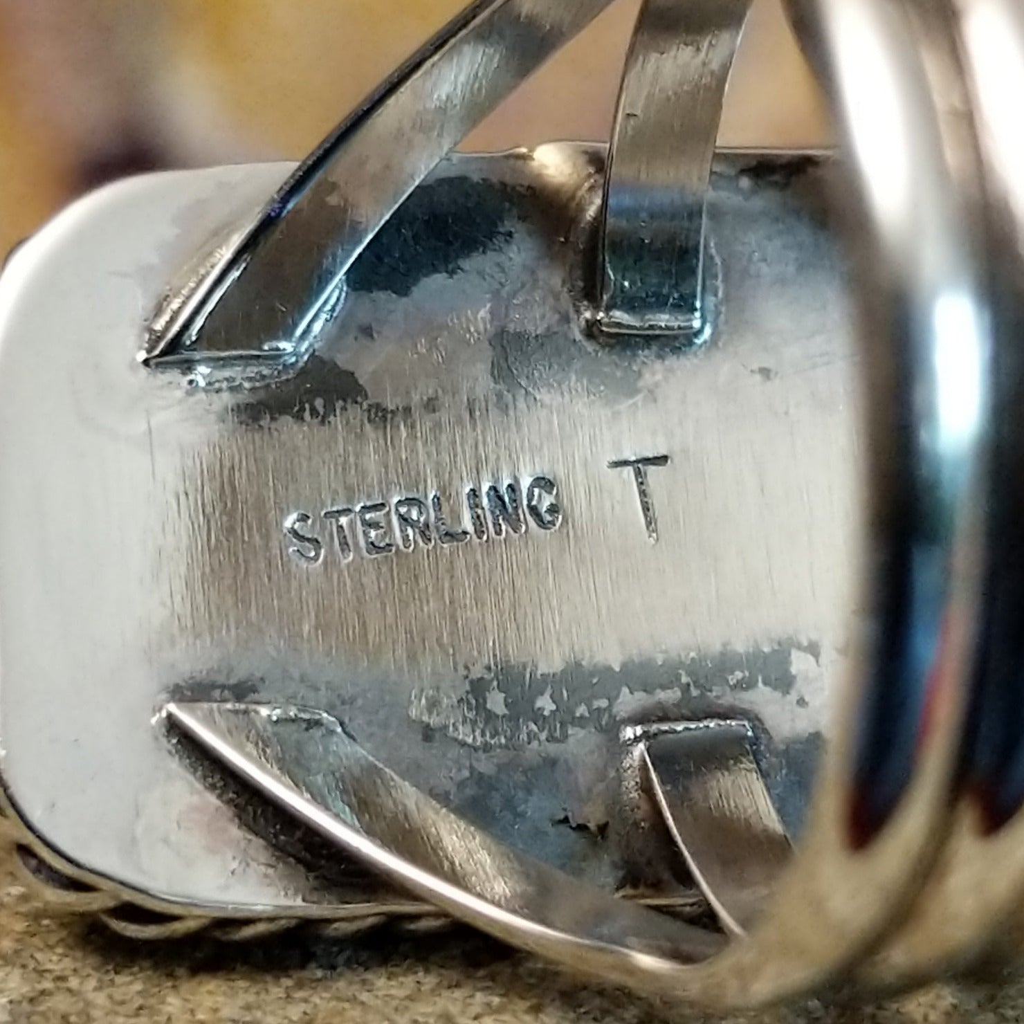 The artisan's stamp is found on the underside of the bezel.