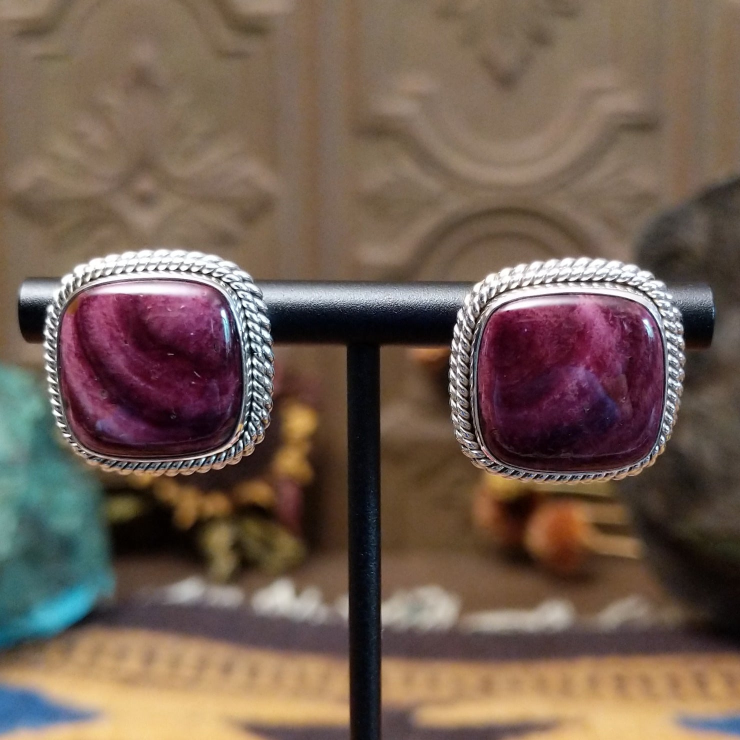 Sterling silver stud earrings featuring purple spiny oyster shell stones with twisted rope detailing.