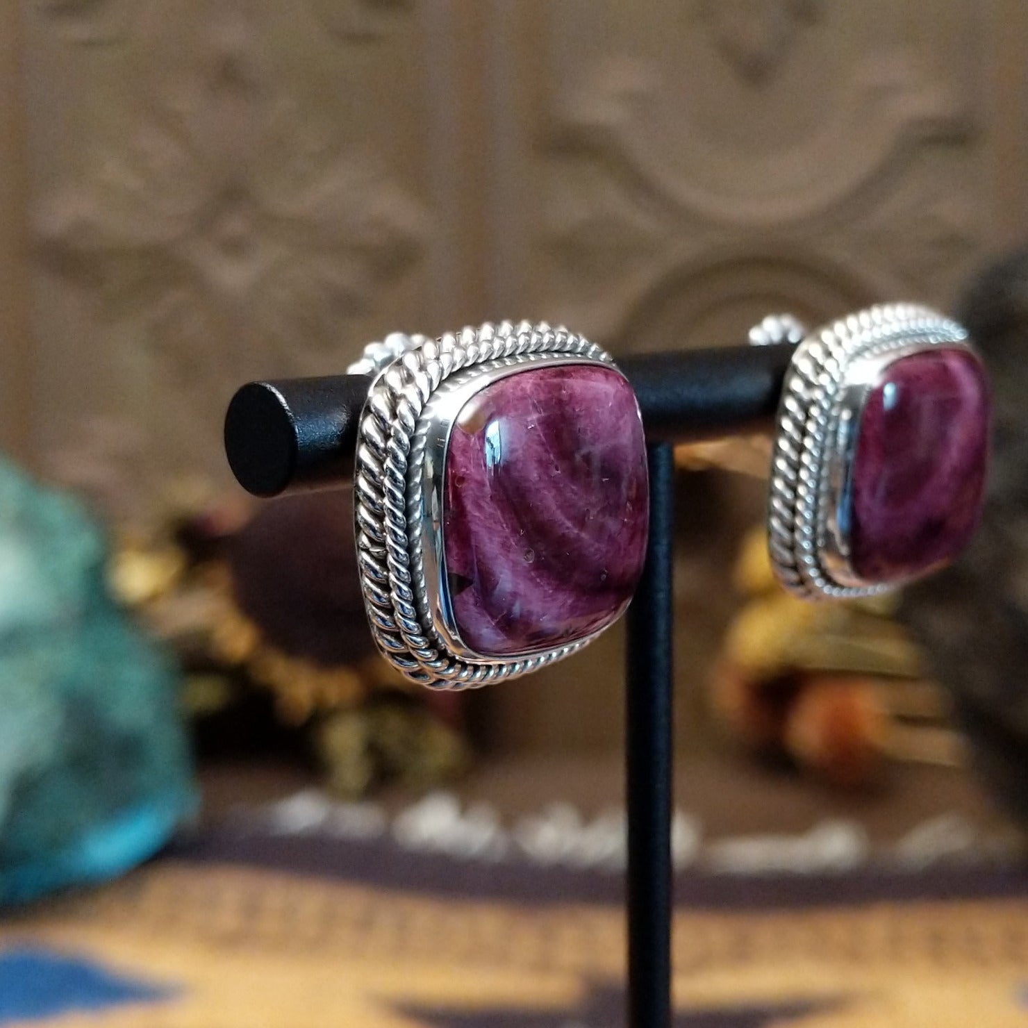 Sterling silver stud earrings featuring purple spiny oyster shell stones with twisted rope detailing.