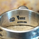 The artisan's stamp is found on the underside of the band.