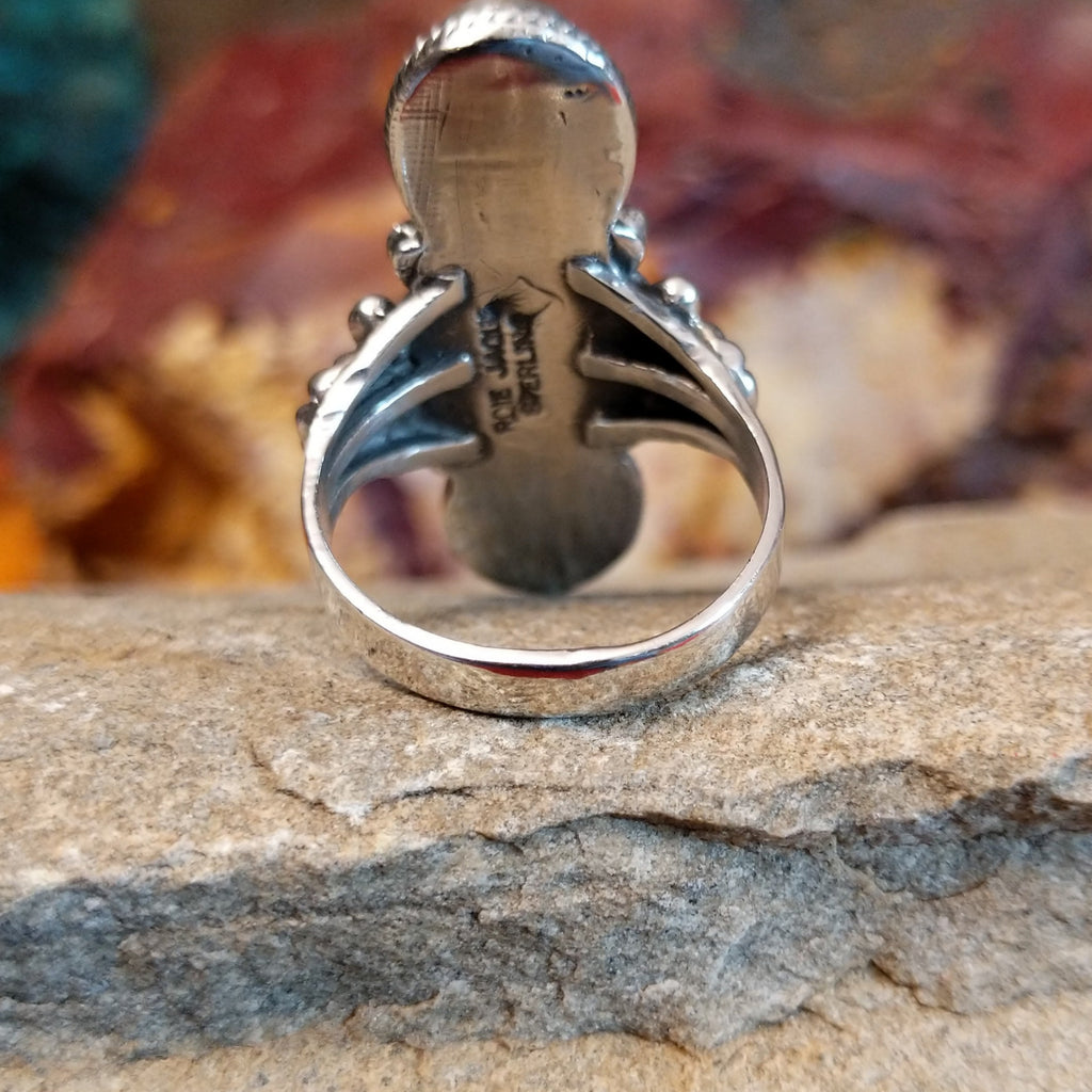 The band of the ring is smooth and polished sterling silver.