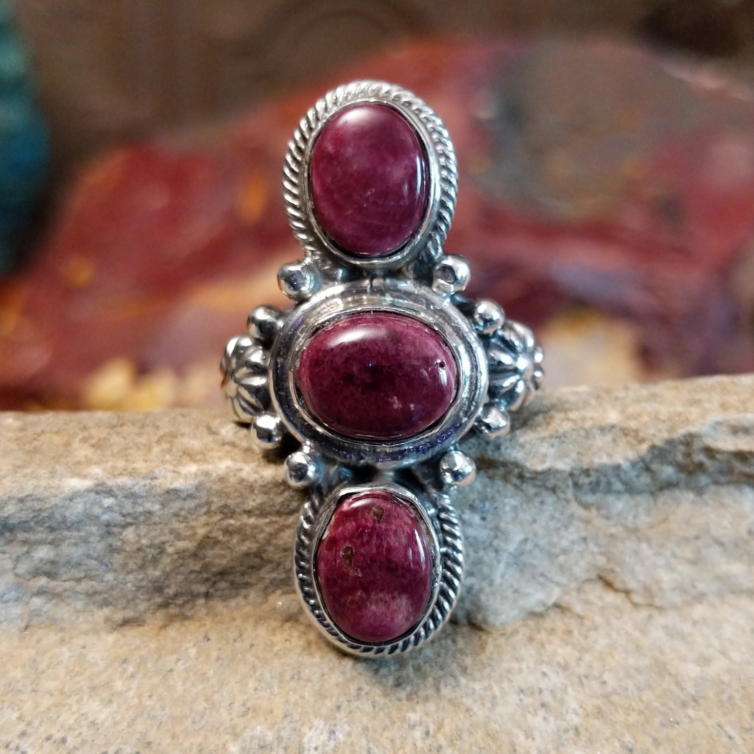 Three purple spiny oyster shells set in an intricate bezel with twisted rope detailing and beading.