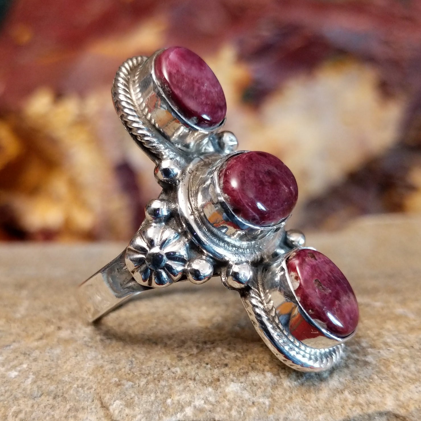 Three purple spiny oyster shells set in an intricate bezel with twisted rope detailing and beading.