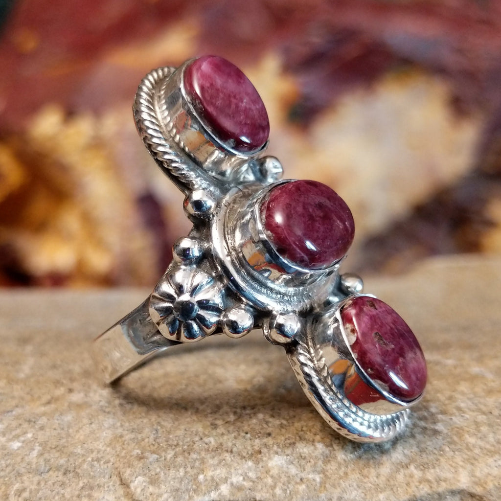 Three purple spiny oyster shells set in an intricate bezel with twisted rope detailing and beading.