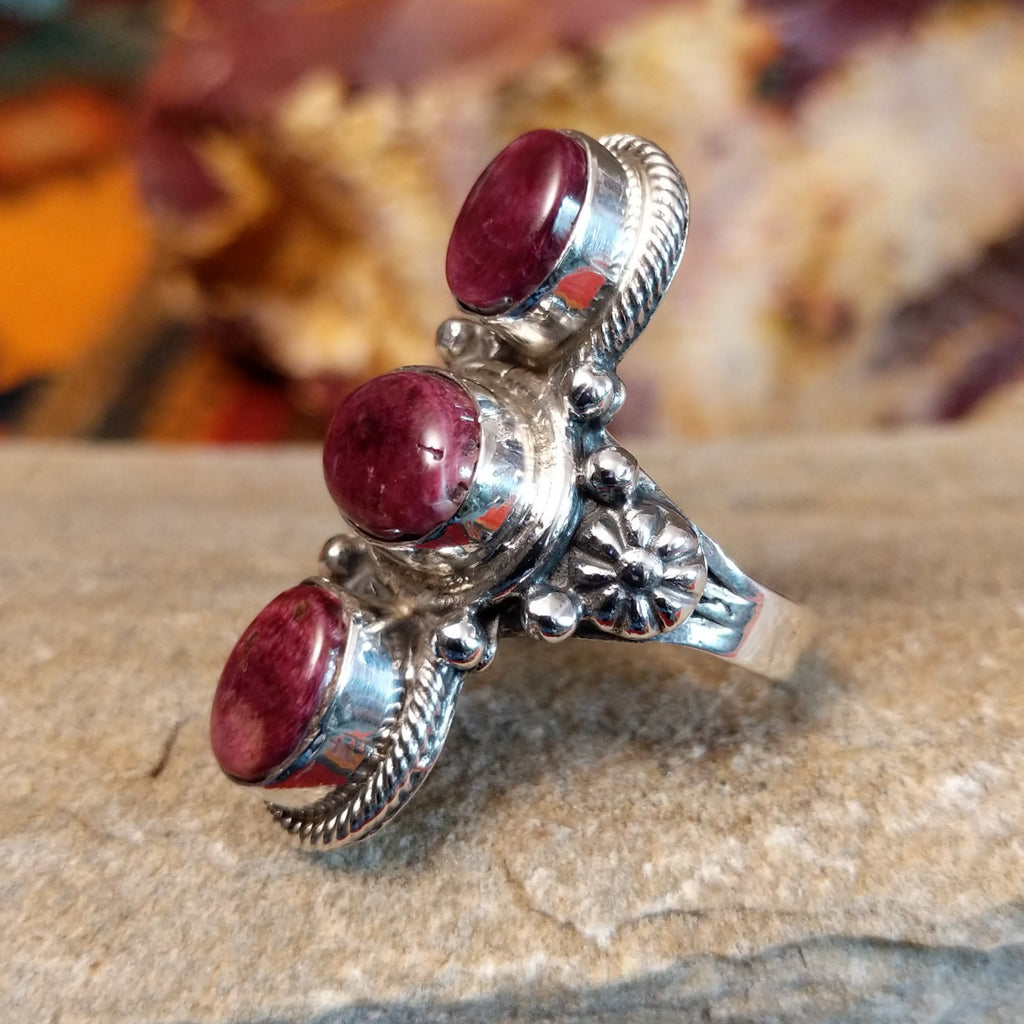 Three purple spiny oyster shells set in an intricate bezel with twisted rope detailing and beading.