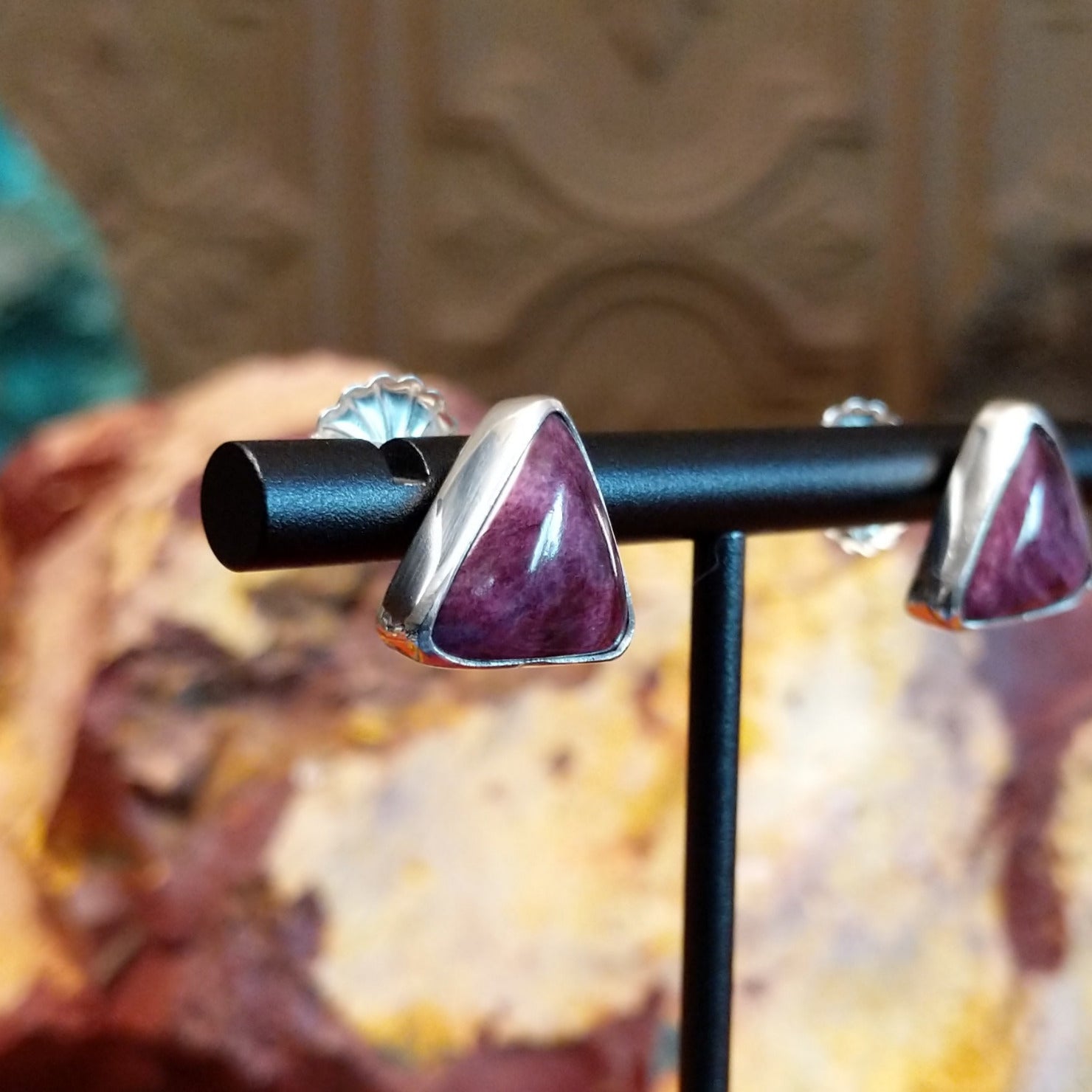Triangular purple spiny oyster shell earrings set in dainty sterling silver frames.