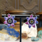 Sterling silver sun earrings with rainbow colored Austrian crystal.